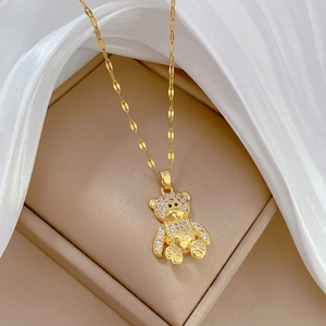 Macro shot of a luxury gold bear pendant with sparkling white pavé crystals in a jewelry box