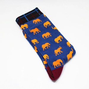 Detail of blue cotton mid-calf socks with orange pixel elephant patterns and red heel