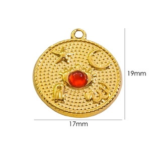 Detailed view of a 17mm gold star and moon celestial pendant with a red gemstone center