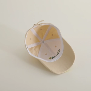 Detail showing inner cotton construction and reinforced tape of the beige baseball cap