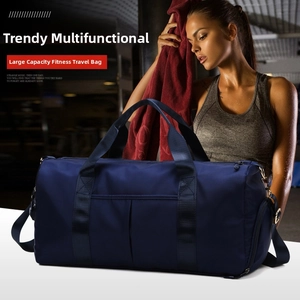 Detail of navy blue fitness bag with adjustable strap and side shoe compartment for gym