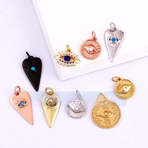 Detail showing multi-style micro-paved evil eye pendants in assorted gold and silver finishes