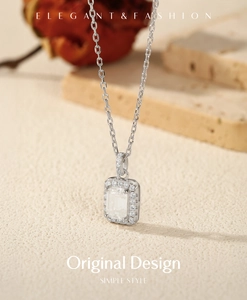 Macro view of emerald-cut moissanite pendant with halo small diamonds on S925 silver chain