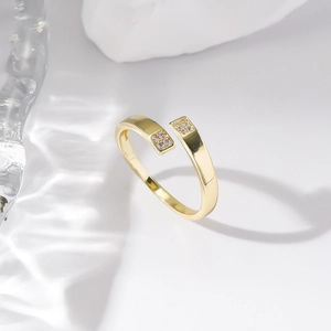 Detailed view of an adjustable gold open ring with a sparkling zircon inlay detail