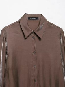 Detail of a brown satin long-sleeved shirt showing the collar and front button texture