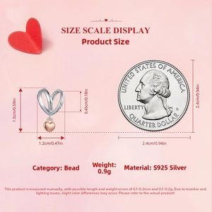 Macro shot of S925 silver hollow heart charm with Family engraving beside a quarter coin