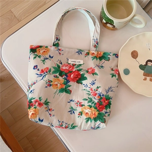 Detail of floral cotton tote bag featuring a 'simple wish' label and vintage flower print
