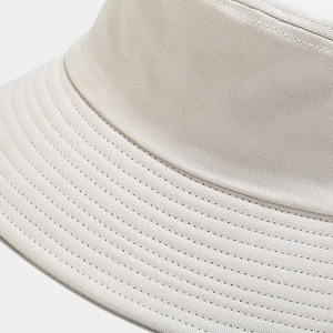 Detailed close-up of cream cotton wide brim sun hat with reinforced multi-row stitching