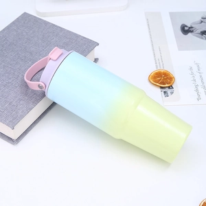 Detail of 30oz tumbler showing gradient blue to yellow body with a purple silicone strap