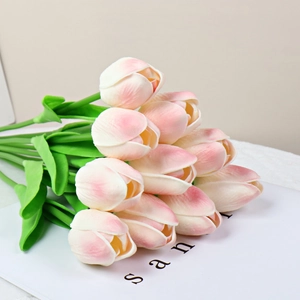 Faux pink and white PU tulips in a bundle resting on a minimalist magazine