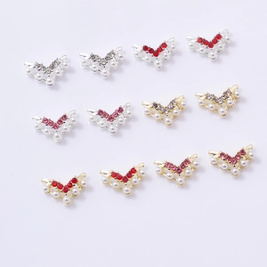 Detailed view of alloy butterfly nail charms with mixed pearls and rhinestones