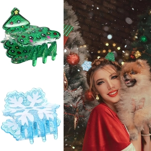 Detail of glittery Christmas tree and snowflake hair claws worn by a model in festive setting