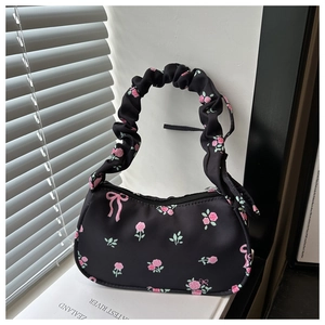 Floral canvas shoulder bag with pink roses, ruffled handle, and bow detail