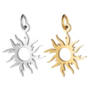 Detailed view of sun-shaped jewelry pendants in polished gold and silver finishes