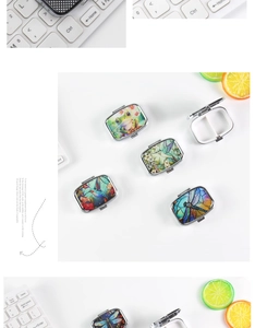 Macro detail of portable metal pill box with 2 compartments and artistic nature designs