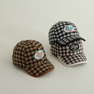 Three children's checkered baseball caps in brown, black, and grey with oval patches