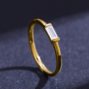 Minimalist S925 sterling silver gold ring with rectangular zircon stone on dark background