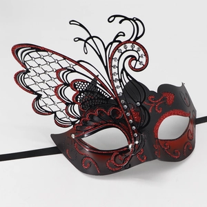 Close-up of luxury metal butterfly mask with red glitter swirls and silver rhinestones