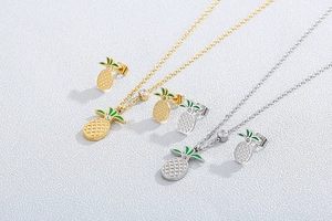 Detail view of pineapple jewelry sets in gold and silver with rhinestones