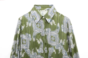 Detail of dark green long sleeve shirt featuring paisley print and vertical texture