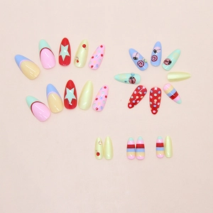 Detailed view of almond-shaped press-on nails with colorful polka dots and rhinestones