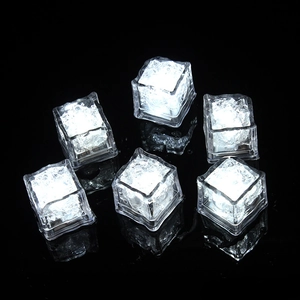Set of 6 square white LED glowing ice cubes with touch sensor on black surface