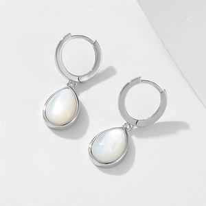 Macro detail of teardrop white shell earrings with s925 silver finish and pearl luster