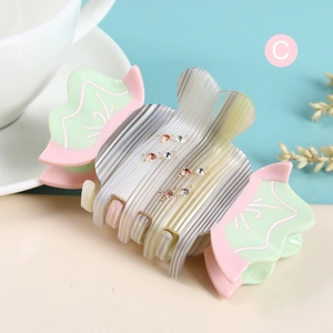 Cute candy-shaped acetate hair claw clip with colorful rhinestones and striped texture