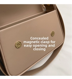 Detail of beige leather bag with double gold magnetic snap closures for easy opening
