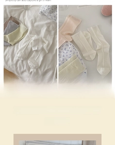 Detailed texture of vertical ribbed knit cotton socks in soft neutral color palette