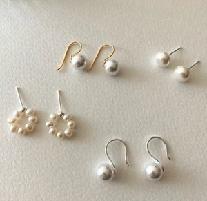 Detailed close-up of 925 sterling silver pearl earrings in various elegant styles