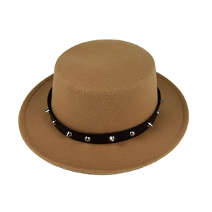 Detail of camel wool fedora hat with black punk belt featuring silver metallic rivets