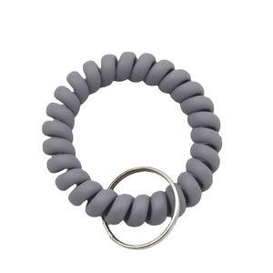 Elastic gray spiral wrist coil keychain with metallic ring on a plain white background