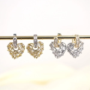 Elegant gold and silver heart-shaped hoop earrings with micro-set cubic zirconia stones