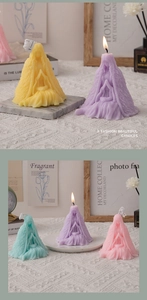 Detail of girl-shaped scented candles in pastel yellow purple blue and pink tones