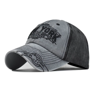 Distressed dark gray cotton baseball cap with embroidered New York text on white background