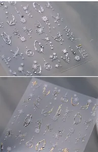 Macro shot of 3D embossed snowflake and star nail art stickers with metallic texture