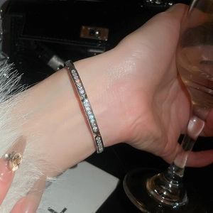 Close-up of 18k gold plated silver bangle with sparkling zircons on a woman's wrist