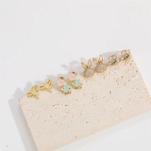 Minimalist gold animal stud earrings set featuring crystal butterfly and bear designs