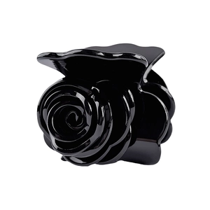Macro shot of 3D black rose hair claw clip with glossy layered acetate petals