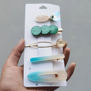 Detail of 5-piece candy color hair clip set featuring gradient blue fish tail and gold beads