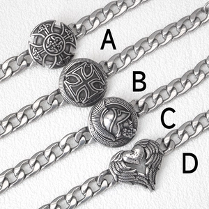 Detail view of four vintage Viking and Celtic style stainless steel Cuban link bracelets