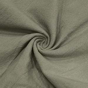 Close-up macro view of olive green linen fabric with soft spiral texture and weave