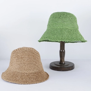 Close-up of green and khaki breathable straw bucket hats with handwoven texture