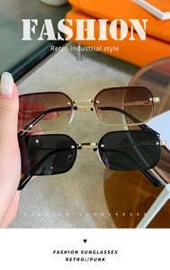 Close-up of retro industrial metal sunglasses with gradient brown and dark black lenses