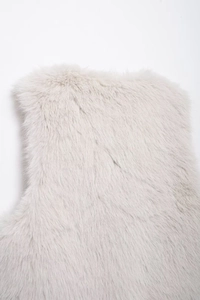 Detailed close-up of cream faux fur texture on the collar and shoulder of the vest