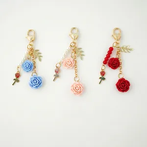 Exquisite resin rose keychain with metal heart clasp in blue, pink, and red colors