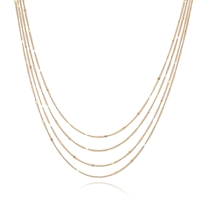 Close-up of layered 18k gold plated stainless steel necklaces with beaded chain detail