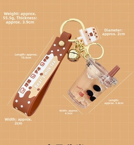 Close-up of bubble tea keychain with liquid bear charm and brown rubber wrist strap