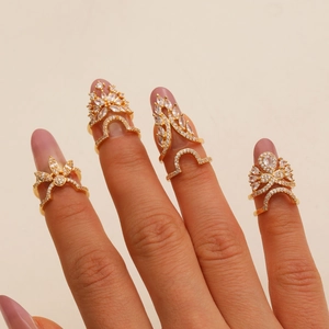 Set of four gold-plated nail rings with sparkling cubic zirconia in floral and leaf designs
